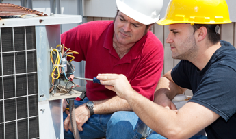 Men Inspecting an AC Unit